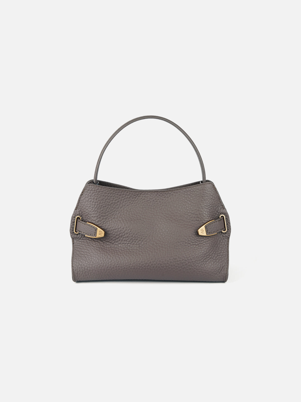 Handcrafted taupe pebbled leather shoulder bag with structured top handle and engraved gold-tone buckle details, isolated on light grey background.