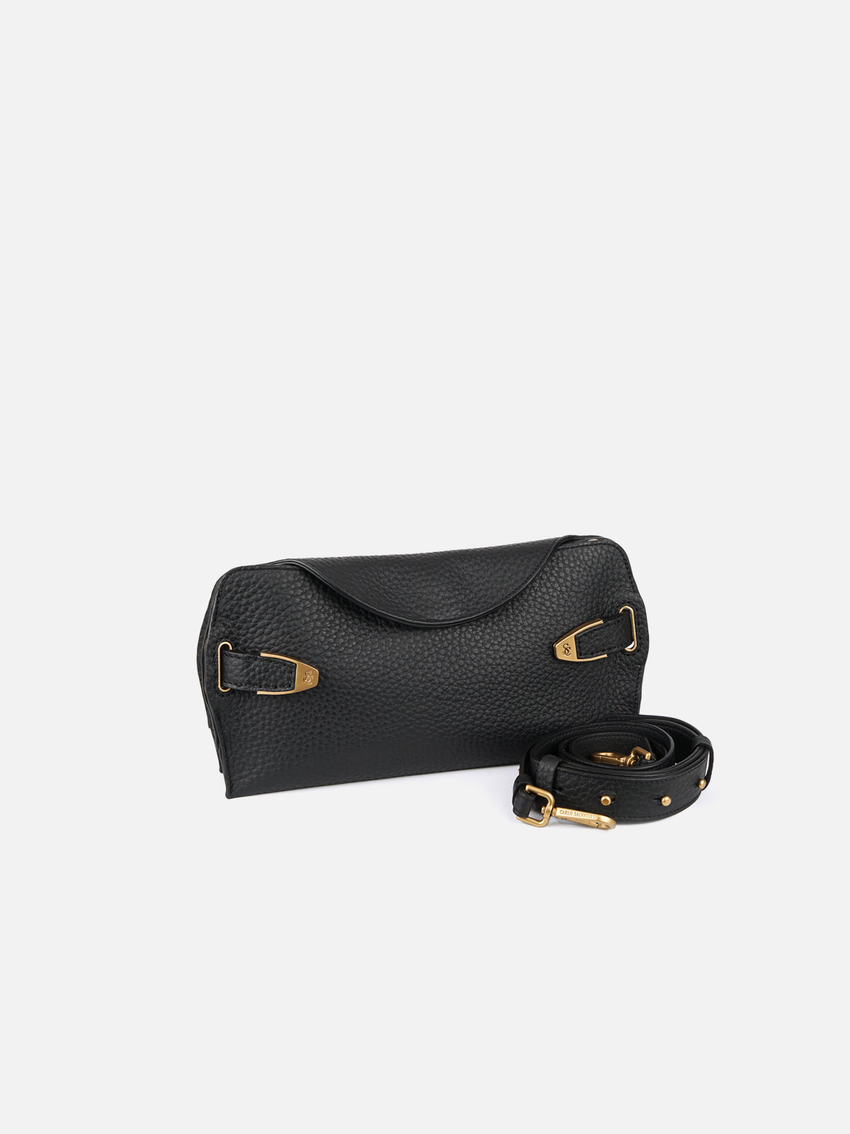 A black pebbled leather clutch bag is displayed against a white background, accompanied by a detached, studded black leather strap. The bag features a curved flap closure, decorative gold hardware, and subtle "SC" logo engravings.