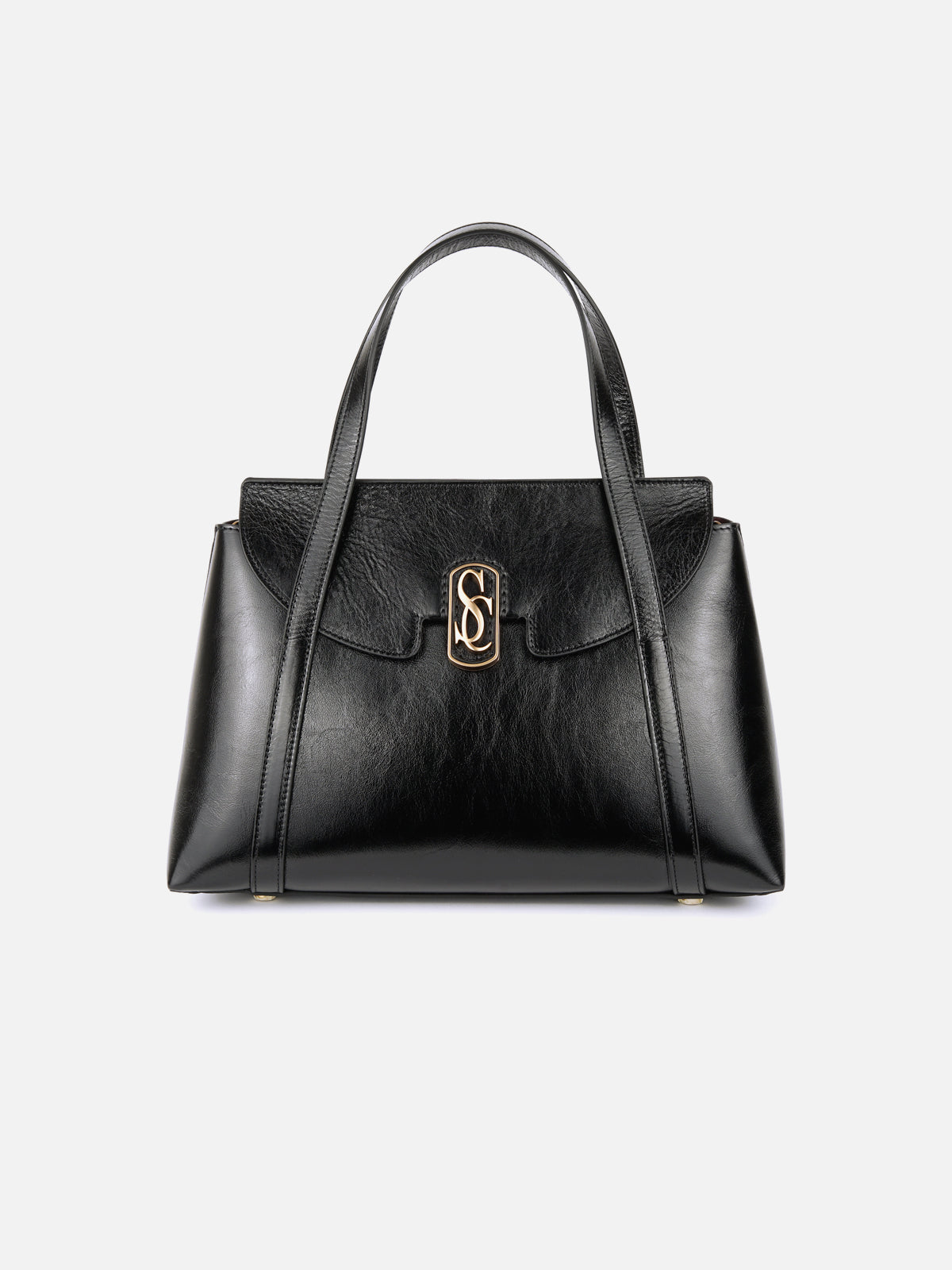 Front view of a sophisticated black high-shine patent leather handbag, featuring a structured trapezoidal body, twin top handles, and a polished gold interlocking monogram closure on the front flap. Set against a light grey background.