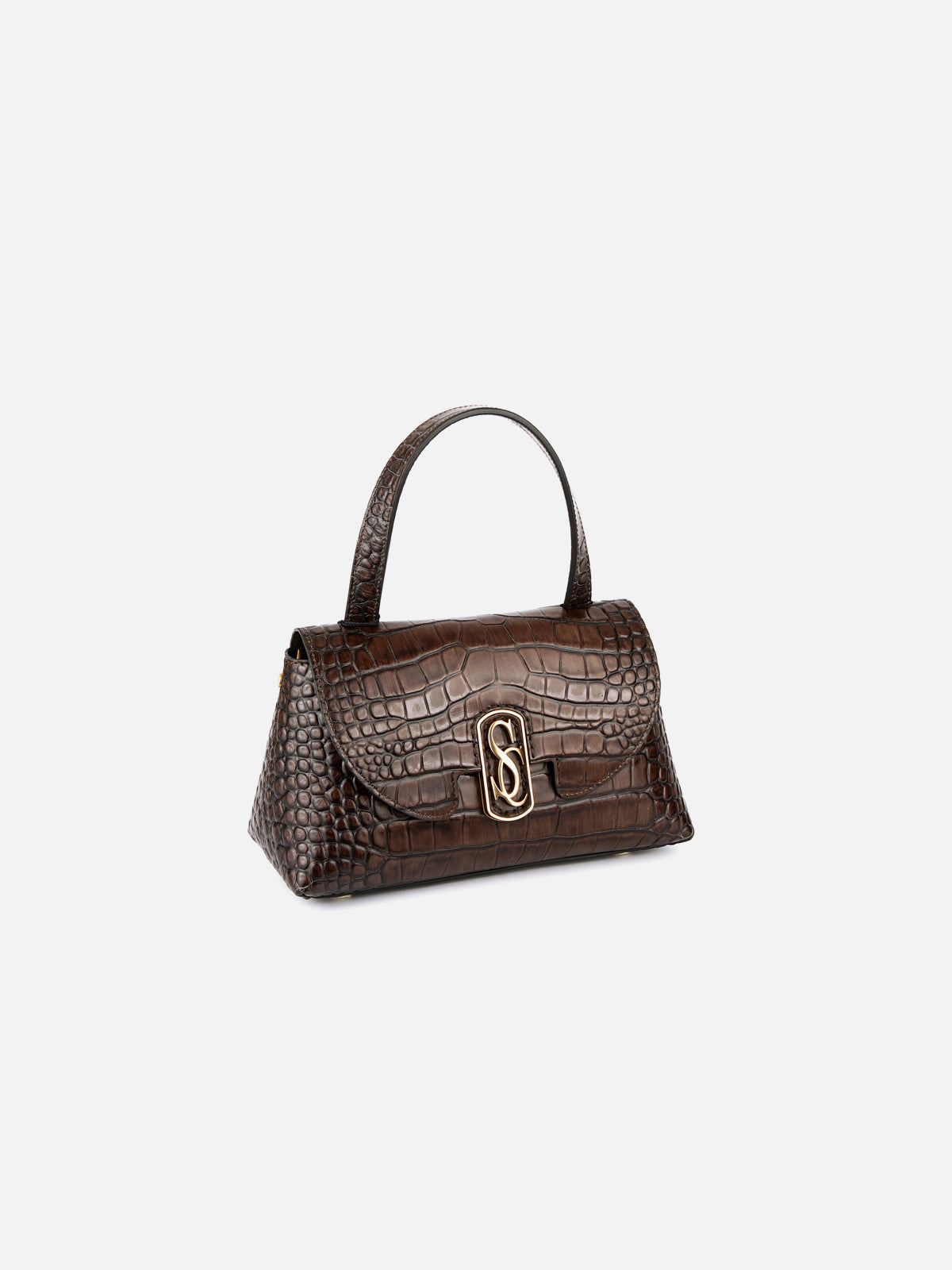 Detailed three-quarter view of a structured, dark brown glossy crocodile-embossed leather top-handle handbag, featuring a prominent central gold-tone interlocking SC monogram clasp. Isolated on a light grey background.
