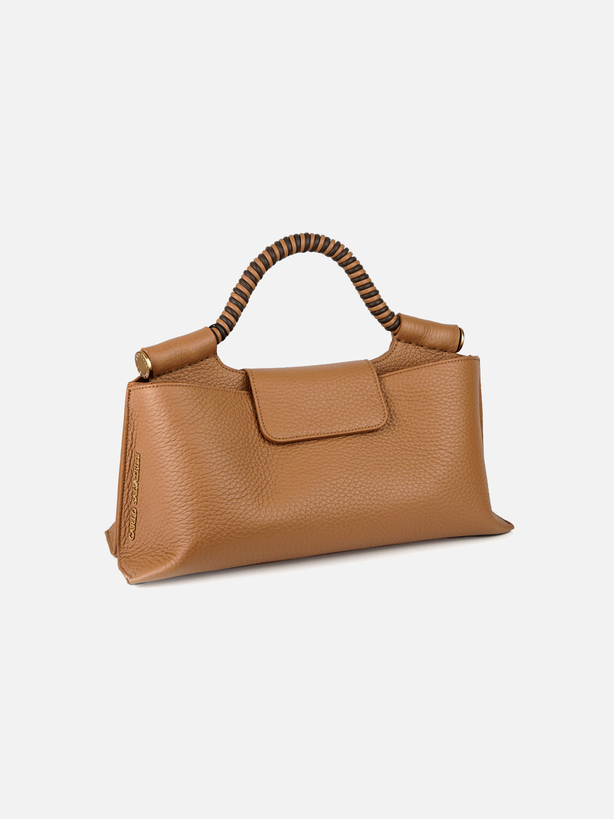 A three-quarter view of a structured, camel-tan pebbled leather handbag featuring a unique braided top handle with alternating brown and dark brown leather strands. The bag has sculptural, pinched-corner side gussets, a central flap closure, and polished gold-tone hardware. The side panel shows a vertical gold logo plate with embossed text.