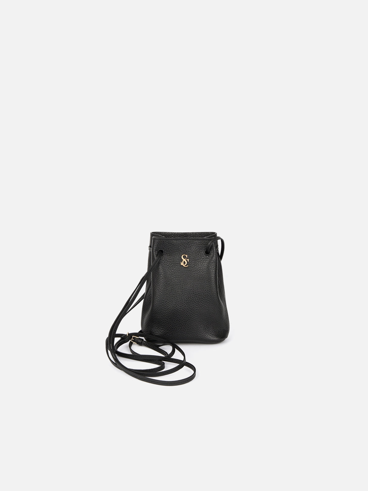 A small black textured leather drawstring or bucket bag with a long, thin adjustable crossbody strap. Features a gold metallic monogram logo centered on the front against a clean white background.