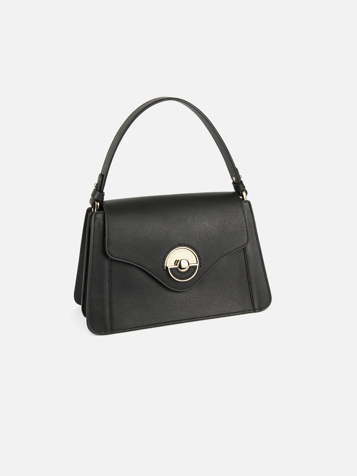 Three-quarter view of a luxury black saffiano leather top-handle bag featuring a front flap with a signature circular gold-tone clasp.