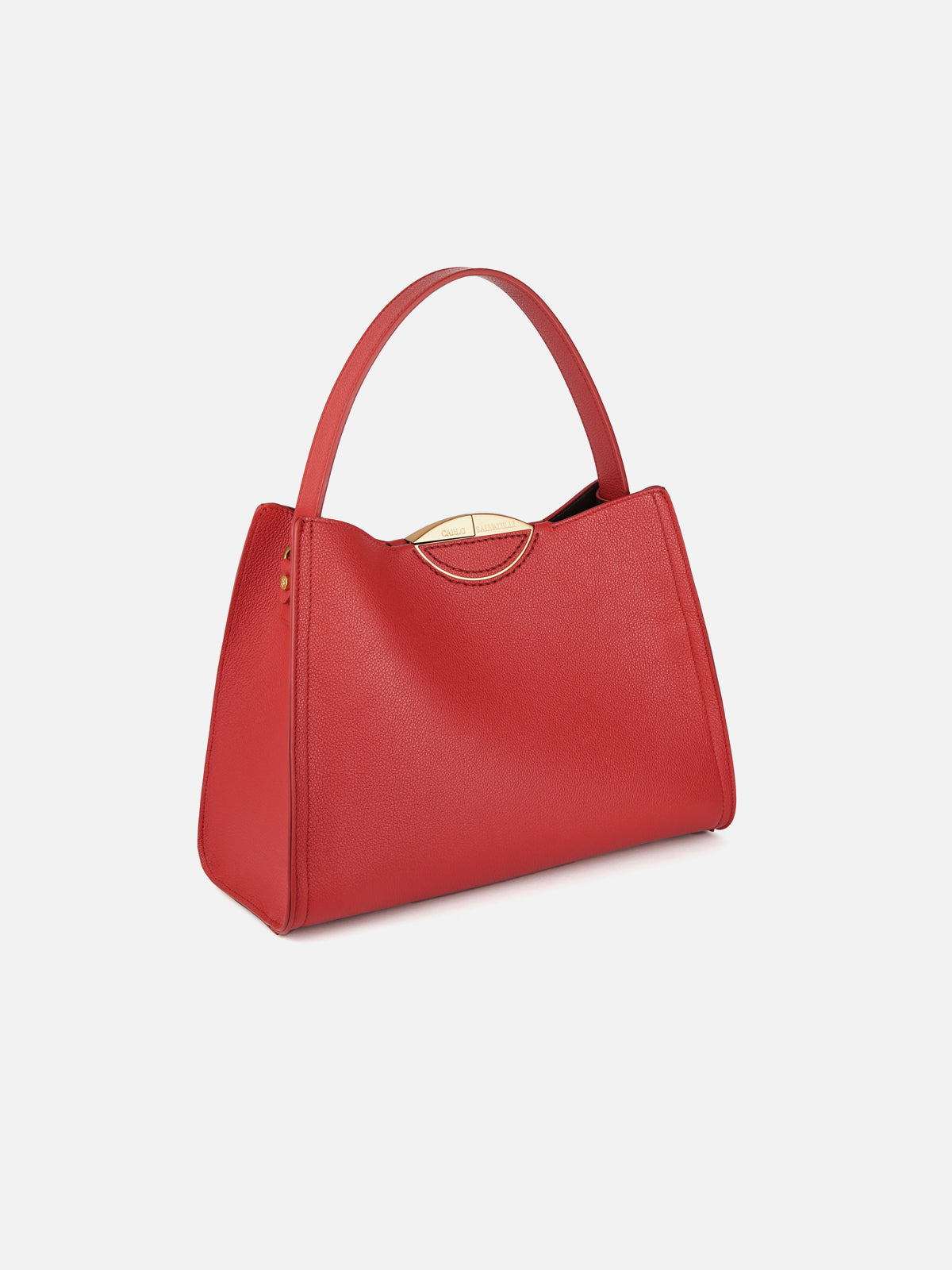 Three-quarter view of a luxury crimson red saffiano leather tote bag featuring a single structured handle and discreet gold-tone hardware along the curved top rim.
