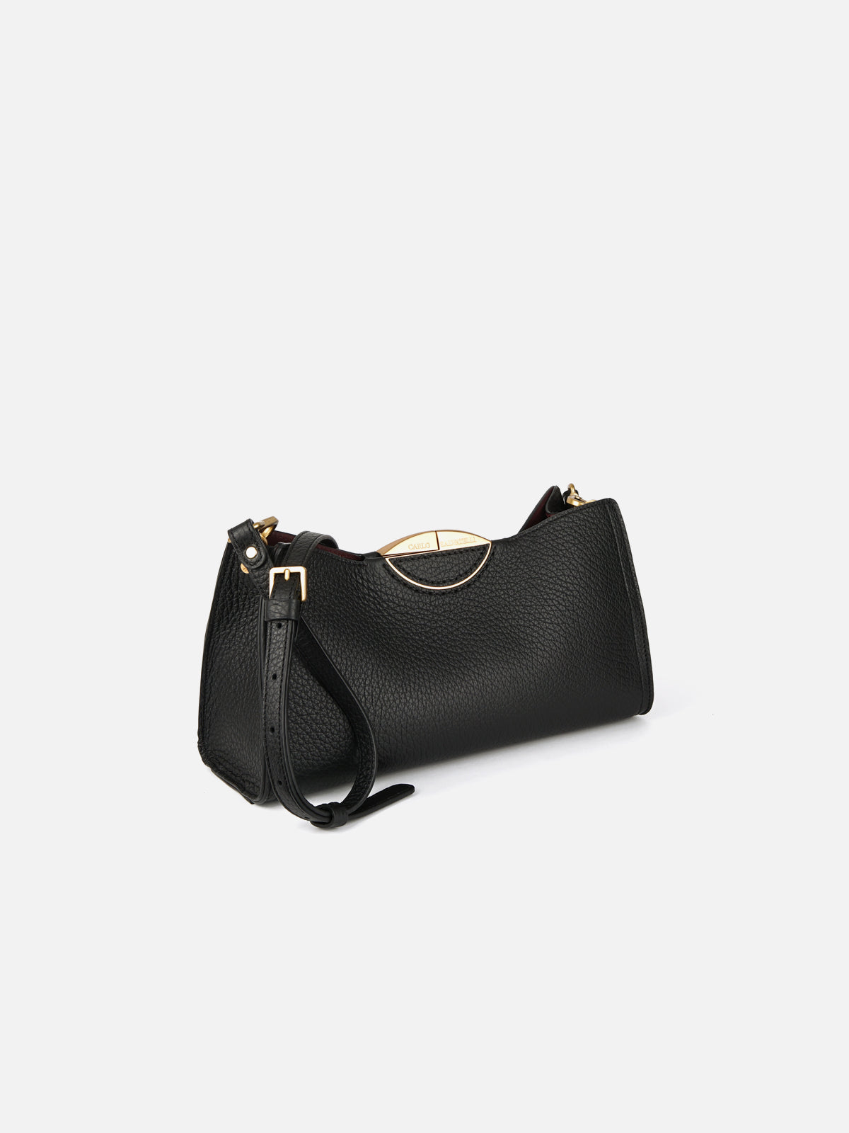Three-quarter view of a luxury black pebbled leather crossbody shoulder bag featuring an adjustable leather strap and signature gold-tone curved trim at the top opening.